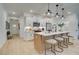 Modern kitchen featuring an island with seating, white cabinets, stainless steel appliances, and light wood floors at 405 Carrera Ln, Acworth, GA 30102