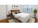 Cozy bedroom featuring modern decor, a comfortable bed with stylish linens, and a view to a window at 2240 Cheshire Bridge Rd # 205, Atlanta, GA 30324