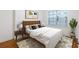 Cozy bedroom featuring a comfortable bed, modern decor, and a bright window with natural light at 2240 Cheshire Bridge Rd # 205, Atlanta, GA 30324