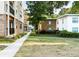 Exterior view of complex with manicured lawns, sidewalks, and mixed brick and stucco facades at 2240 Cheshire Bridge Rd # 205, Atlanta, GA 30324