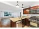 Open kitchen with stainless steel appliances, a granite island, and seamless flow into the living area at 2240 Cheshire Bridge Rd # 205, Atlanta, GA 30324