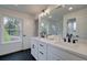 Modern bathroom with double sinks, vanity, a large mirror and black hardware at 401 Carrera Ln, Acworth, GA 30102