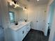 Modern bathroom with double sinks, white cabinets, and black accents at 401 Carrera Ln, Acworth, GA 30102