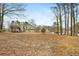 Large backyard with mature trees and wood chips at 4036 Evelyn Dr, Powder Springs, GA 30127