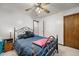 Charming bedroom with ceiling fan, dark-colored bedding, and wrought iron bed frame at 4036 Evelyn Dr, Powder Springs, GA 30127