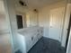 Modern bathroom with a long white double vanity, a large mirror, and dark floors at 417 Carrera Ln, Acworth, GA 30102