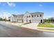 Row of townhouses with attached garages and landscaping at 417 Carrera Ln, Acworth, GA 30102