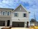 New two-story townhome showcases gray siding, gray shutters, and a spacious, attached two-car garage at 417 Carrera Ln, Acworth, GA 30102