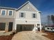 Exterior of a new gray townhome with a 2 car garage and gray shutters at 417 Carrera Ln, Acworth, GA 30102