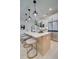 Kitchen island with quartz countertop and barstools at 417 Carrera Ln, Acworth, GA 30102