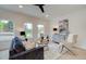 Bright living room with navy blue sofa and plenty of natural light at 417 Carrera Ln, Acworth, GA 30102