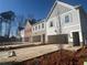 View of new gray and brick townhomes with 2 car garages, and blue sky at 417 Carrera Ln, Acworth, GA 30102