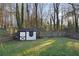 White shed in a wooded backyard setting at 437 Cherry Tree Ln, Marietta, GA 30066