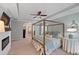 Spacious main bedroom with a large four-poster bed and fireplace at 437 Cherry Tree Ln, Marietta, GA 30066