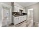 Updated kitchen with white cabinets and gray tile backsplash at 540 Hamilton E Holmes Nw Dr, Atlanta, GA 30318