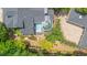 Stunning aerial view of a luxury home featuring a spa, sunroom, brick patio, koi pond, and beautifully landscaped grounds at 117 N Cove Dr, Peachtree City, GA 30269