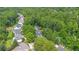 Aerial shot of a neighborhood with mature trees and lush green surroundings in a serene, wooded environment at 117 N Cove Dr, Peachtree City, GA 30269