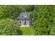Beautiful home with lush green lawn, mature trees, manicured landscaping, and charming double staircase entry at 117 N Cove Dr, Peachtree City, GA 30269
