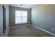 A cozy bedroom featuring neutral walls, a bright window, and plush carpeting at 2566 Walden Lake Dr, Decatur, GA 30035