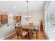 Bright breakfast nook with window seating and chandelier at 630 Birnamwood Dr, Suwanee, GA 30024