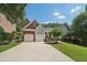 Brick front house with two-car garage and landscaped lawn at 630 Birnamwood Dr, Suwanee, GA 30024