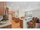 Open kitchen with island, breakfast bar, and hardwood floors at 630 Birnamwood Dr, Suwanee, GA 30024