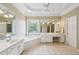 Large main bathroom with double vanity and soaking tub at 630 Birnamwood Dr, Suwanee, GA 30024