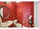Elegant powder room featuring red patterned wallpaper at 630 Birnamwood Dr, Suwanee, GA 30024