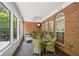 Sunroom with brick walls and wicker furniture at 630 Birnamwood Dr, Suwanee, GA 30024