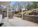 Outdoor patio with seating area and a stone retaining wall at 976 Cardova Ne Dr, Atlanta, GA 30324