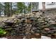 Serene backyard waterfall feature with stonework at 976 Cardova Ne Dr, Atlanta, GA 30324