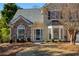 Front entrance with stone details and landscaping at 5375 Ashwind Trce, Alpharetta, GA 30005