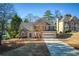 Two-story house with stone accents, attached garage, and landscaping at 5375 Ashwind Trce, Alpharetta, GA 30005