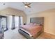 Spacious main bedroom with a large bed and ceiling fan at 100 Jessamine Trl, Lawrenceville, GA 30046