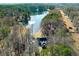 Aerial view of house on lake with wooded area at 1126 Wedgefield Dr, Marietta, GA 30064