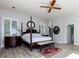 Spacious main bedroom with a large four-poster bed, hardwood floors, and plenty of natural light at 1126 Wedgefield Dr, Marietta, GA 30064