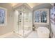 Bathroom boasting a large walk-in shower, soaking tub, and marble finishes at 4340 Garmon Nw Rd, Atlanta, GA 30327