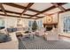 Spacious Gathering room featuring exposed wooden beams, a cozy fireplace, and ample natural light at 4340 Garmon Nw Rd, Atlanta, GA 30327