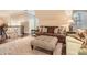 Comfortable sitting area with brown sofa, ottoman, and large windows at 4340 Garmon Nw Rd, Atlanta, GA 30327