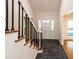 Bright entryway with tile flooring and staircase with black railings at 5109 Cherry Ln, Powder Springs, GA 30127