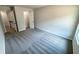 Bedroom with gray carpet, window, and access to a closet and hallway at 1341 E Atlanta E Rd, Stockbridge, GA 30281