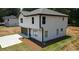 Two-story house with gray roof, white siding, and a paved driveway at 1341 E Atlanta E Rd, Stockbridge, GA 30281