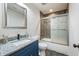 Bathroom with shower/tub combo, granite vanity and dark tile floor at 2127 Nichols Ln, Decatur, GA 30032