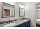 Double vanity bathroom with granite countertops and blue cabinets at 2127 Nichols Ln, Decatur, GA 30032