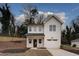 Two-story farmhouse with white siding, black roof, and attached garage at 2127 Nichols Ln, Decatur, GA 30032