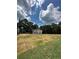 House with open field, large trees and partly cloudy skies at 1351 E Atlanta E Rd, Stockbridge, GA 30281