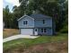 Newly built 2-story house with a gray driveway and attached garage at 1351 E Atlanta E Rd, Stockbridge, GA 30281