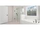 Spa-like bathroom with a soaking tub, glass shower, and modern fixtures at 2719 Byess Ct, Marietta, GA 30064