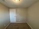 Simple bedroom with carpet and neutral wall colors at 5464 Martins Crossing Rd, Stone Mountain, GA 30088