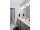 Bathroom featuring double sinks, white marble countertops and a shower/tub combo at 290 Walker Ave, Alpharetta, GA 30076